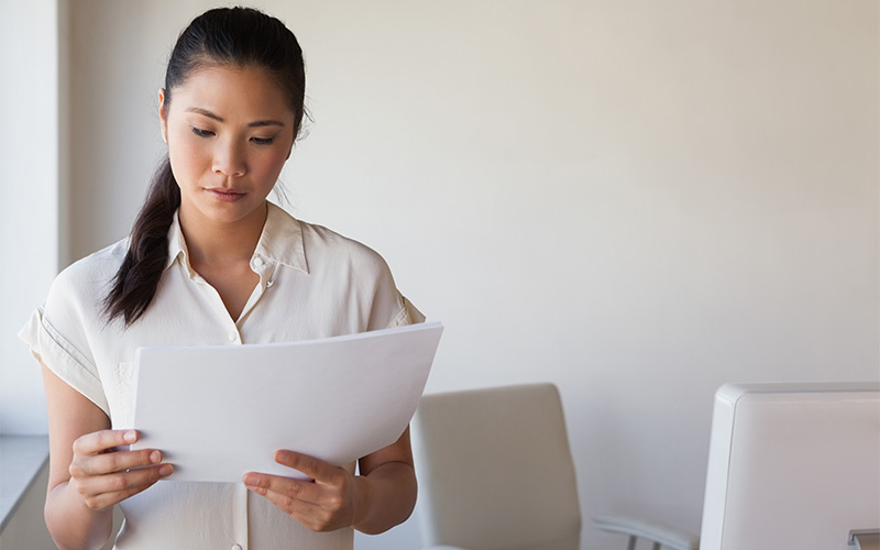 A stock photo related to a person checking papers.