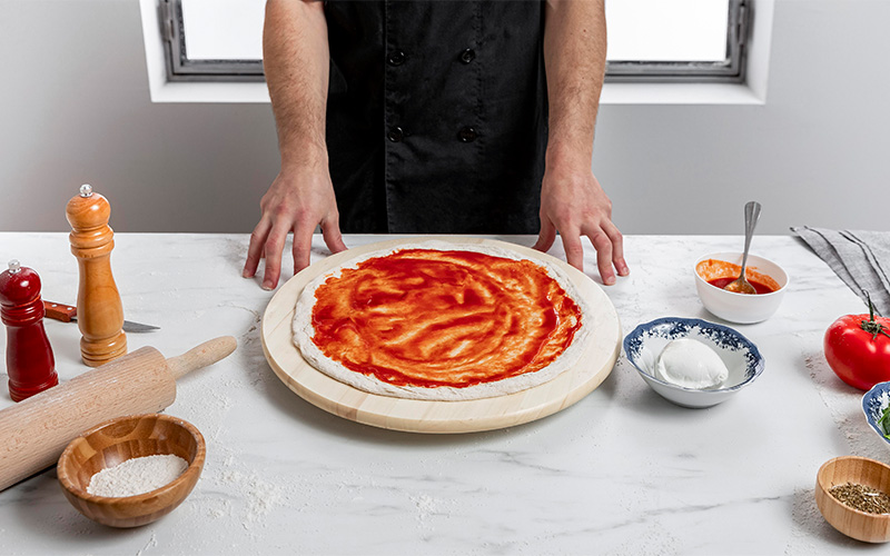 Image of a person making a pizza at home
