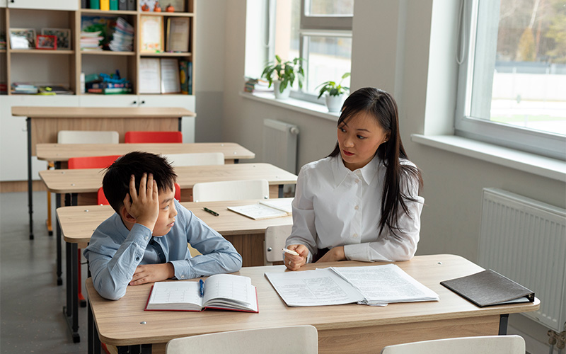 Image of a teacher having a one-on-one discussion with a student