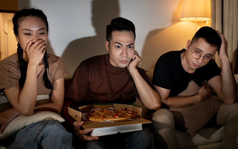 A person binge-watching with food