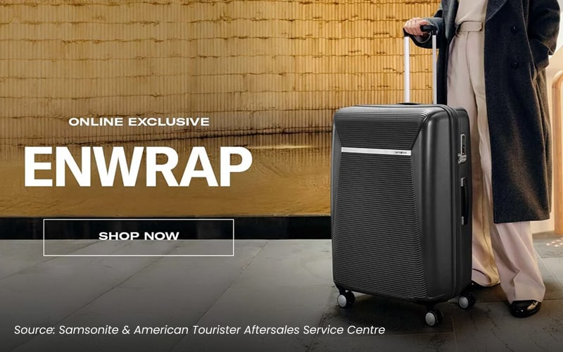 A person posing with a black suitcase from Samsonite