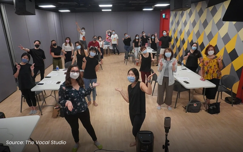 A group of students taking a singing class at The Vocal Studio