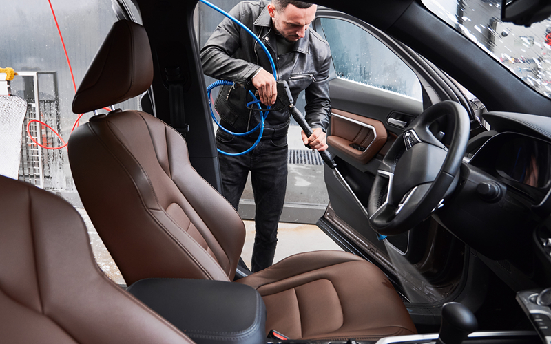 Image of a person cleaning the car interior