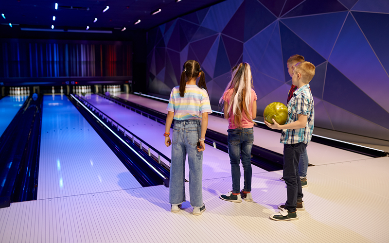 Image of a young kids playing bowling