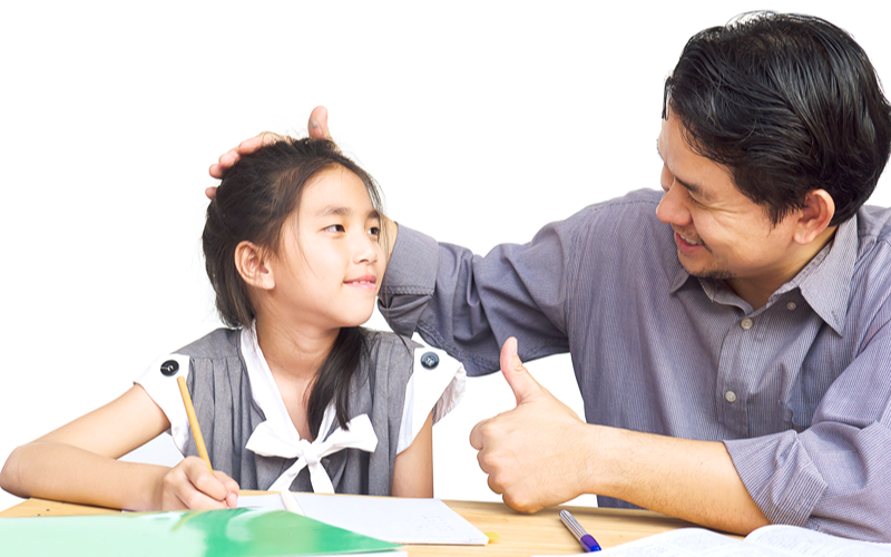 Image of a young student showing a perfect scored test