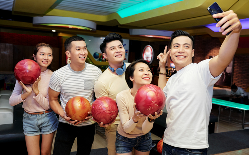 Image of people holding bowling balls