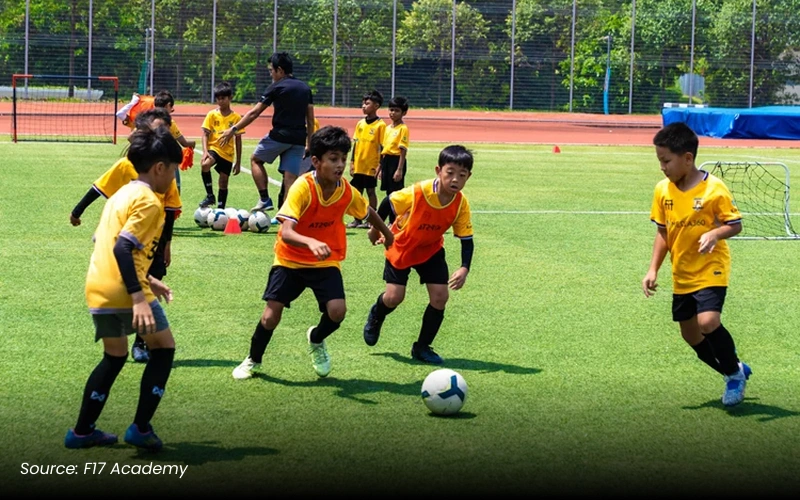 Young boys from F17 Academy playing football on a field