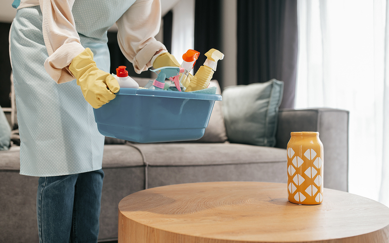 Image of a cleaning service tidying up a living room