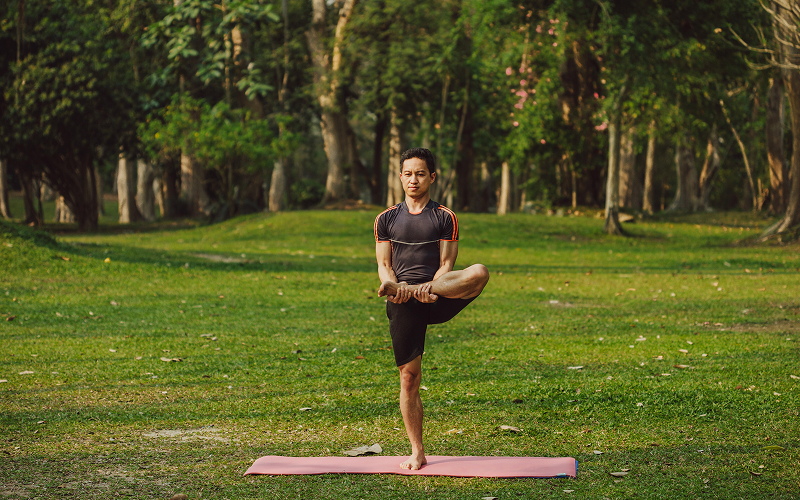 a person practising a yoga in an outdoor environment