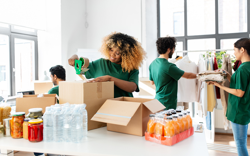 a student working on a community charity organisation packing donation boxes
