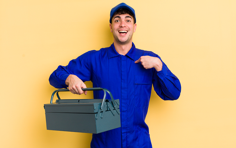 a technician in uniform holding a toolbox