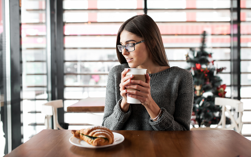Image of a person having breakfast at a cafe