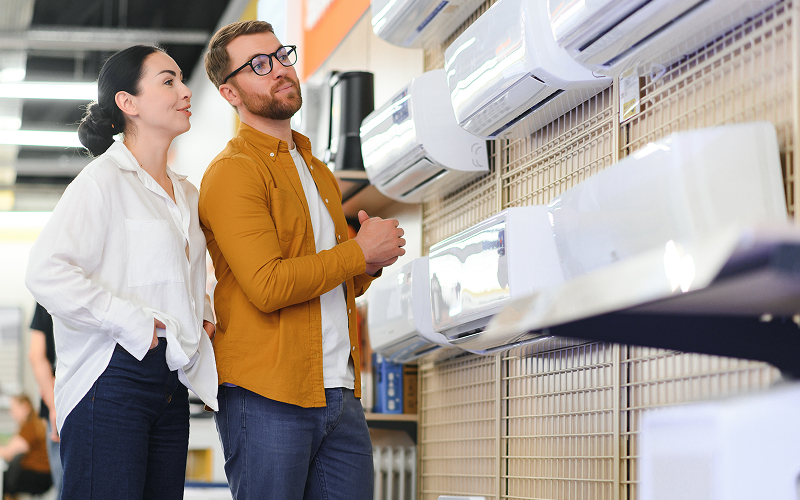 a person checking aircon units at an appliance store