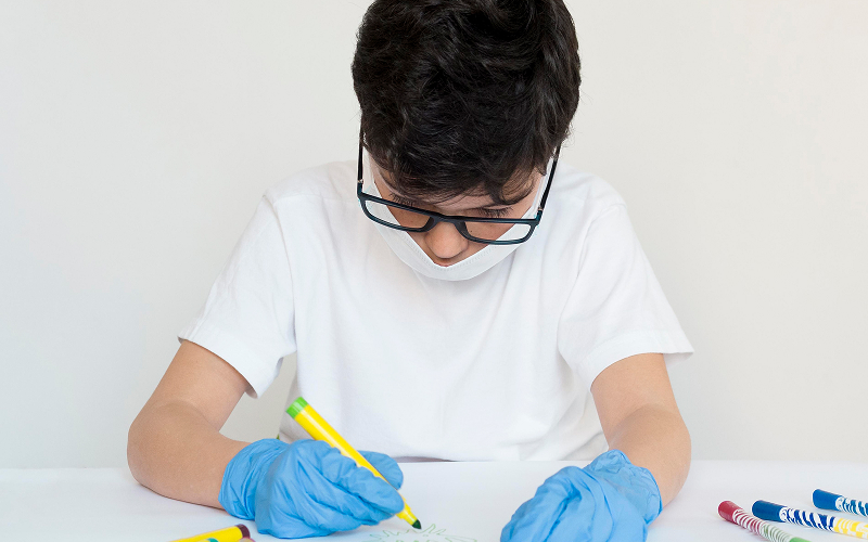 Student drawing with markers during an upper primary science experiment.