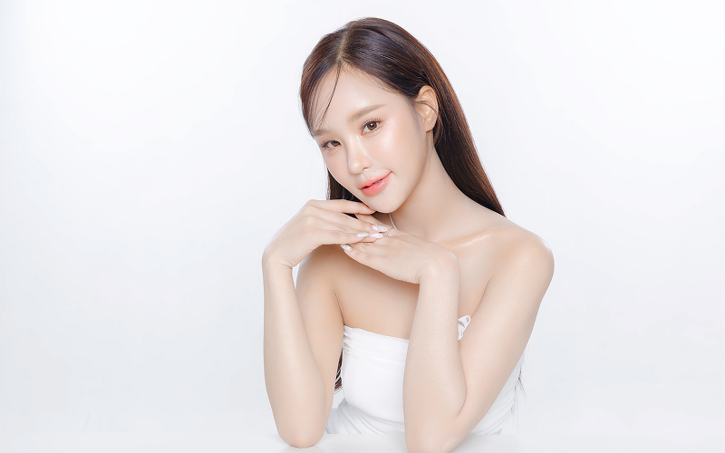 An asian person with radiant, natural-looking skin